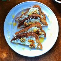 The Honey Goat Toast · 9 grain toast with a goat cheese spread, topped with chopped walnuts and honey.