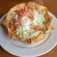 Taco Salad · Flour tortilla bowl filled with beans, cheese, lettuce, pico de gallo and sour cream. Ground...
