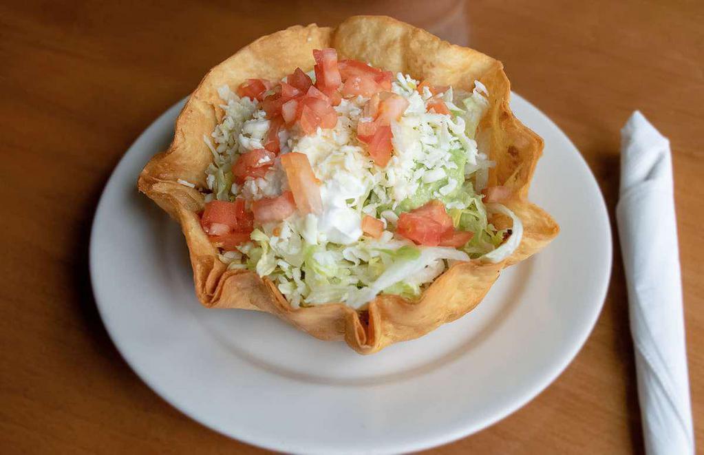 Taco Salad · Flour tortilla bowl filled with beans, cheese, lettuce, pico de gallo and sour cream. Ground beef or chicken, mix (chicken and beef) for an additional charge. Extras for an additional charge.