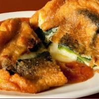 Chile Relleno · Is a stuffed green poblano pepper filled with chihuahua cheese that has been breaded, fried,...