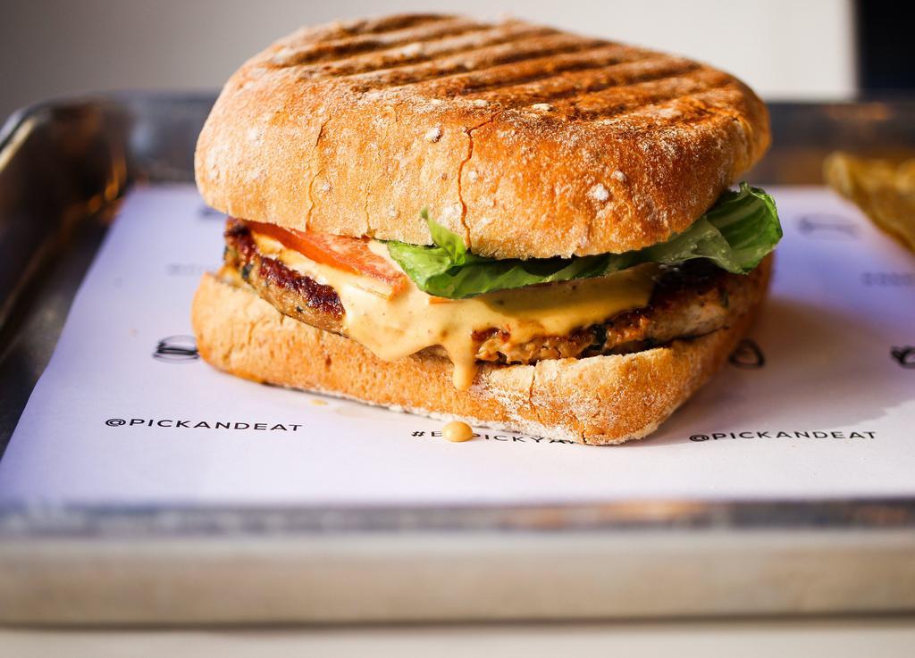 Turkey Mex Burger · Freshly lean ground turkey and fresh herbs patty. Topped with lettuce, fresh avocado, ripe tomato, and onions with chipotle sauce. Served in a ciabatta whole wheat square bun with yellow corn baked chips.
