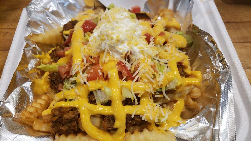 Papas Locas -- Mami's Loaded Plate · Loaded French fries with 3 meats (Pulled pork, Ground Beef, and Chicken in a mustard, ketchup, Mayo and spices mix) top with lettuce, tomatoes, creamy nacho cheese and sour cream