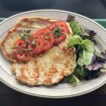 Chicken Paillard  · Sliced tomato, fresh basil leaf and seasonal greens.