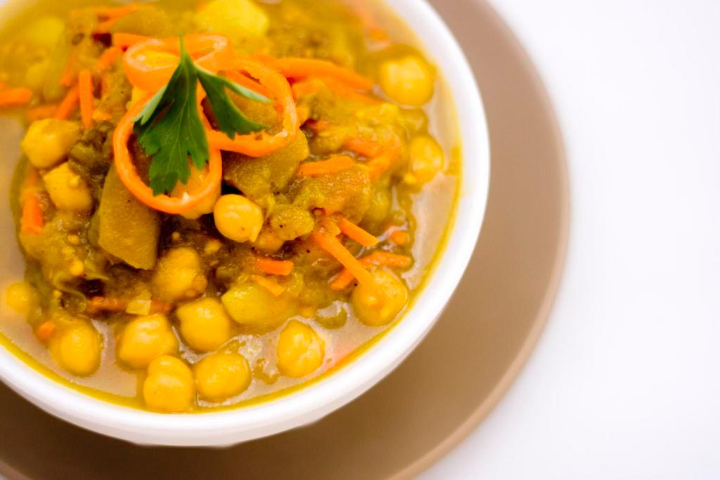 Eggplant Curry · Mild eggplant in curry with garbanzos, potatoes, carrots & seasoning over brown rice.