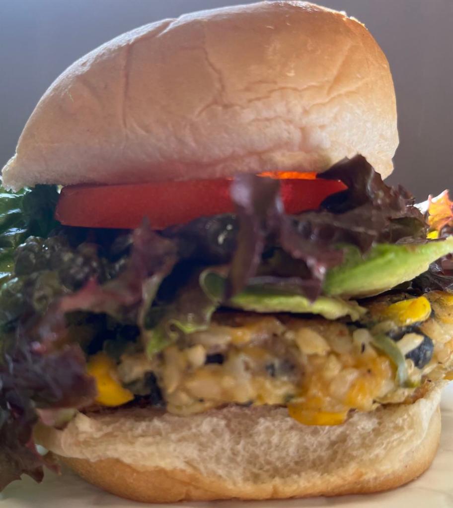 Spicy Southwest Burger with Avocado · Delicious spicy patty from black beans, jalapeño, brown rice, corn, vegan cheese, spices & seasoning. Lettuce, tomato, onion & vegenaise sauce.