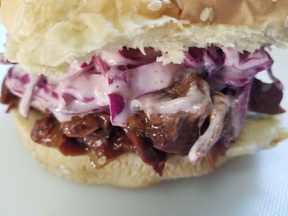 Pulled BBQ Jackfruit · Young shredded seared jackfruit in BBQ sauce topped with red cabbage slaw.