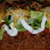 Texas Taco · Fresh seasoned ground beef topped with lettuce, tomato, sour cream, mixed cheese and bacon. ...