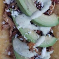 Adobo Chicken Taco · Slow roasted chicken in a semi spicy sauce with Adobo peppers, onions, jalapenos, topped wit...