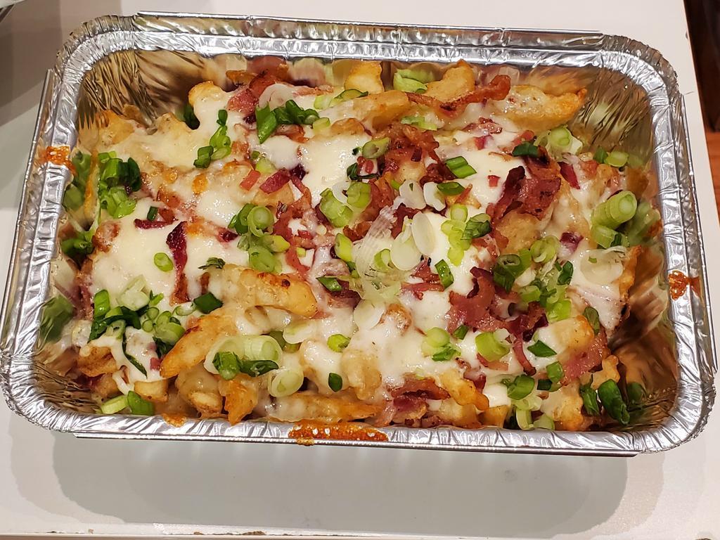 Loaded Fries · Fries server with bacon and cheese sauce. Garnish with green onions.