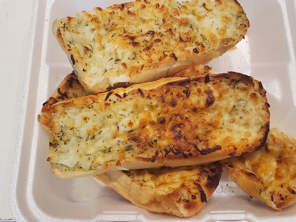 Cheesy Garlic Bread · 4 slices of baguette bread topped with garlic butter and tossed with a mixer of cheeses.