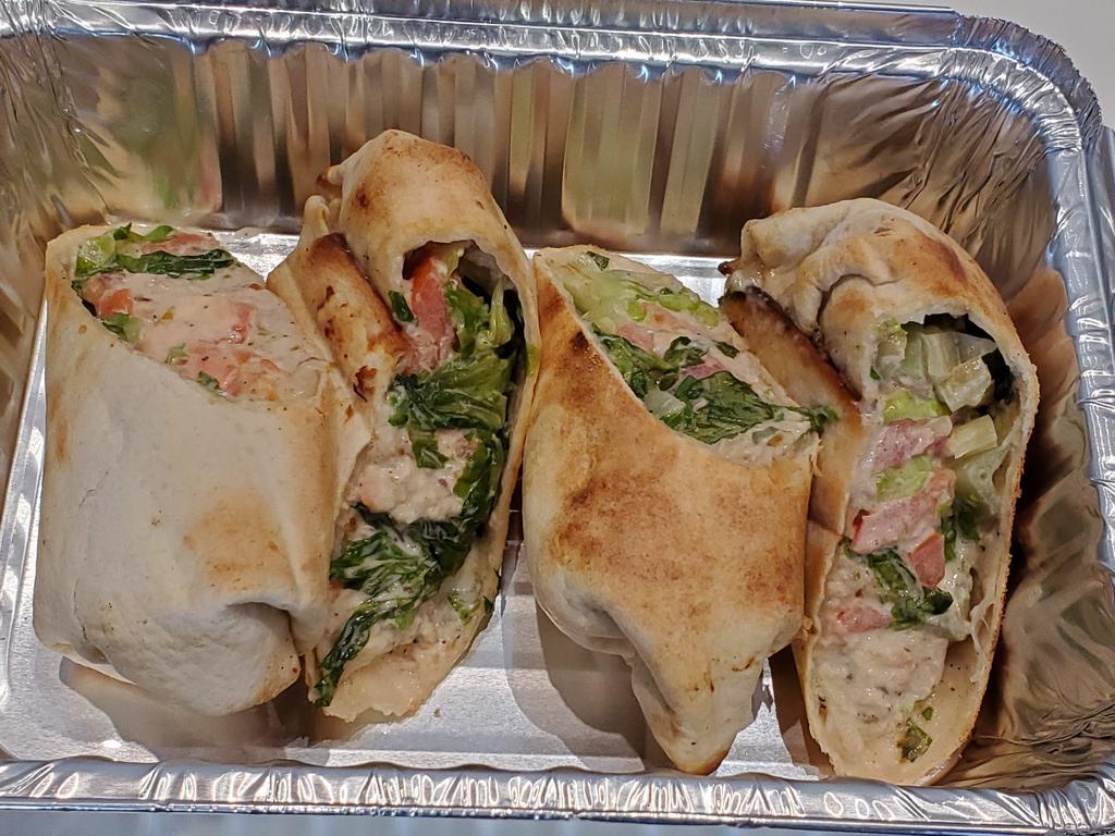 Tuna Wrap · Tuna seasoned with white and green onions, wrapped with jerk mayo, tomatoes, and lettuce.
