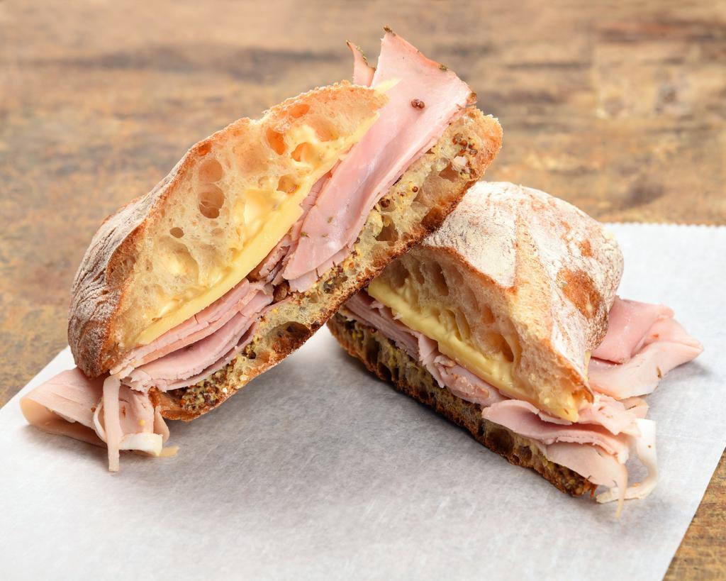 Ham and Cheddar Sandwich · Rosemary ham, aged cheddar, whole grain mustard, mayo with freshly baked ciabatta.