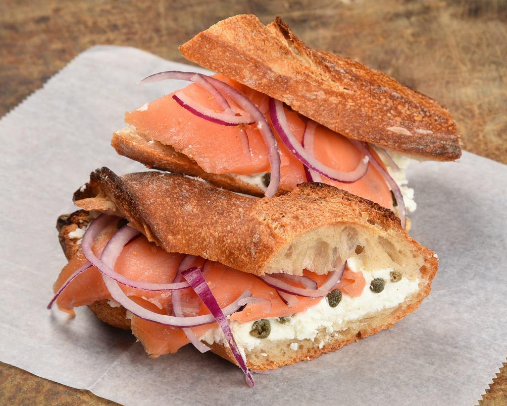 Smoked Salmon Sandwich · Smoked salmon, fresh goat cheese, capers & onion with freshly baked baguette.