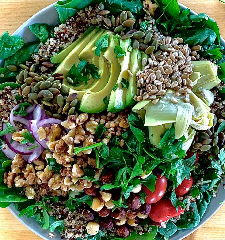 Quinoa Hearty Vegan bowl with Balsamic Dressing · **Balsamic Dressing - Vegan, Keto, Gluten Free**
Organic tricolor quinoa, cherry tomatoes, cucumber, artichoke hearts, couscous, red onion, pumpkin seeds, sunflower seeds, walnuts, hazelnuts, avocado, parsley 
