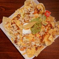 Loaded Nachos with chicken. · Fresh chips topped with charro beans, fresh queso, mesquite grilled chicken breast, lettuce,...