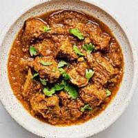 Lamb Curry · Lamb meat with bone cooked with gravy sauce and spices. Spicy.
