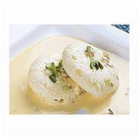 2 Rasmalai · Soft cheese patties in delicately sweeten and flavored creamy milk sauce.