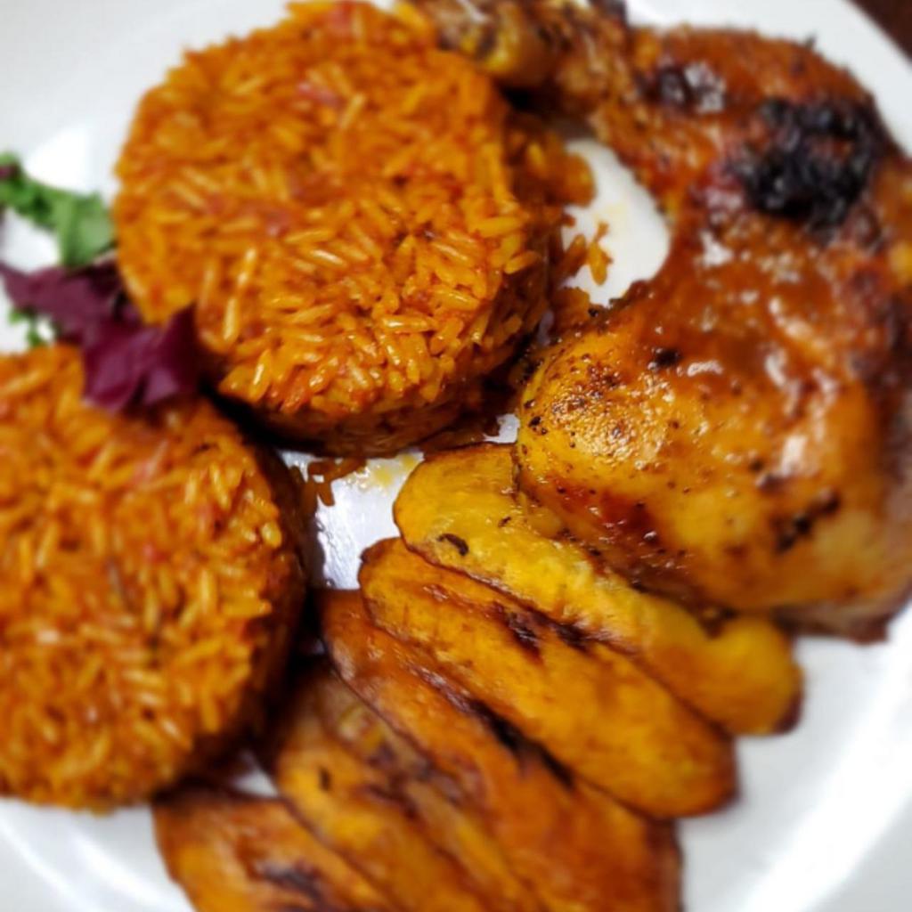 Jollof Rice · A West African mainstay, also called Benachin is a flavorful tasty rice, simmered in spicy savory deep fried tomato stew. It is served with fried plantain and your choice of meat. 

Want the vegan option? It is served with fried plantain.
