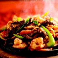 Fajitas Texanas · Tenders strips of beef, chicken and shrimp, grilled onions, tomatoes and peppers.