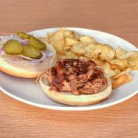 Pulled Pork Sandwich · Perfectly pulled pork,  texas style bbq sauce, onions, and pickles on a hamburger bun.