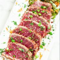 Blackened Tuna App · 6 pieces of lightly seared black pepper coated tuna drizzled with a delicious citrus ponzu s...