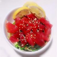 Poke Salad · Slices of marinated ahi tuna, julienned cucumbers, kaisou salad and green onions, drizzled w...