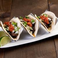 Beef Taco · 3 soft corn tortilas filled with grilled marinated skirt steak, onions, cilantro and chile d...