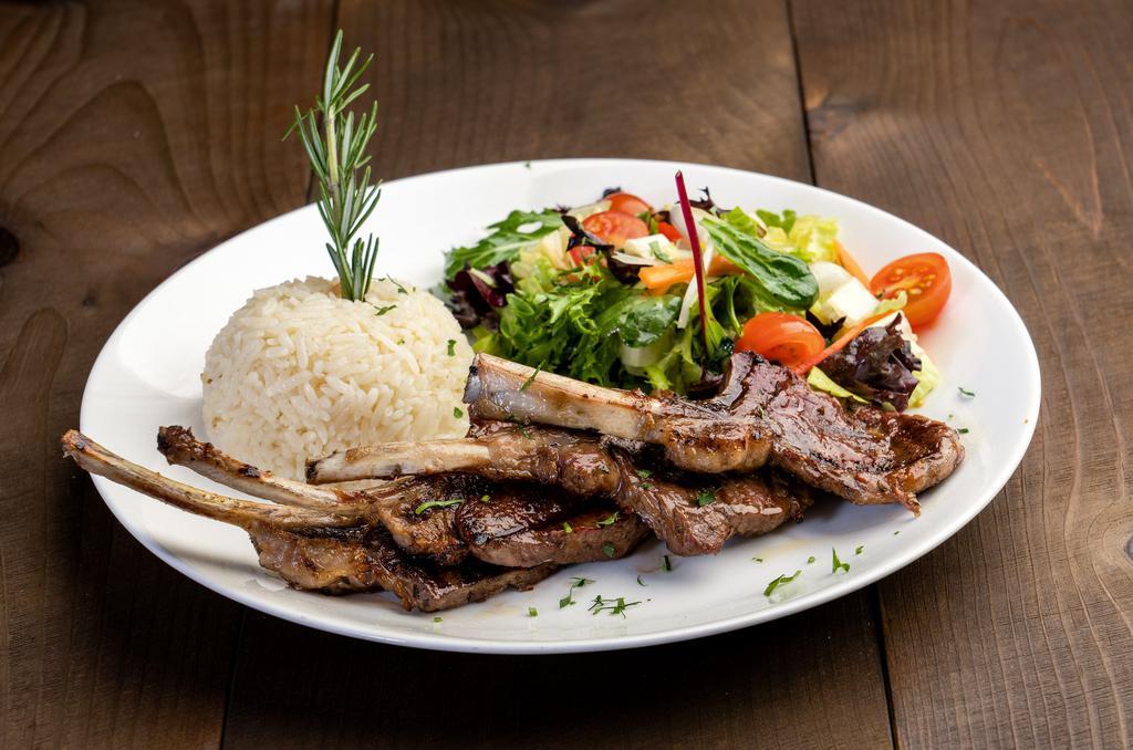Baby Lamb Chops · Tender lamb chops marinated in our chef's special sauce and grilled to perfection. Served with house salad and rice.