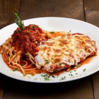 Chicken Parmigiana · Breaded chicken breast covered in tomato sauce and mozzarella and Parmesan cheese. Served ov...