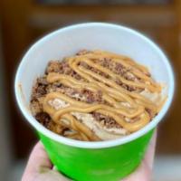 Peanut Butter Lover · 9 oz. of classic chocolate frozen yogurt topped with Reece's peanut butter cups, butterfinge...