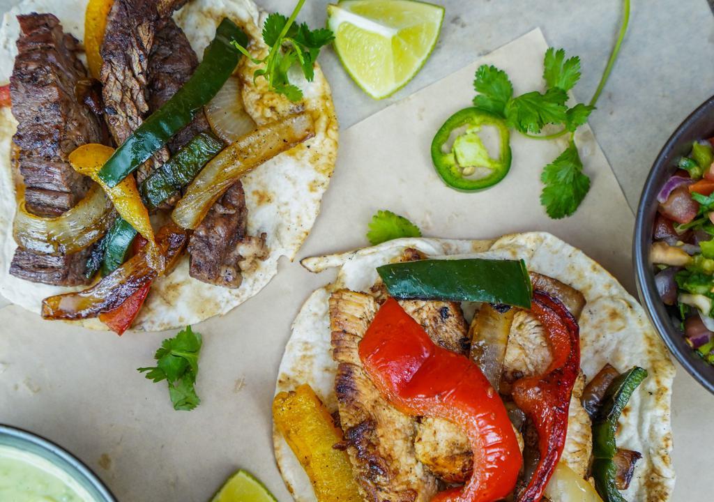 Fajita · All fajitas are served with rice and bean with a setup of fresh guacamole and Pico de Gallo and 3 flour or corn tortillas with your choice of steak, chicken, or combination. Served with sautéed onions and bell pepper.