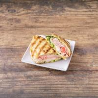 Monte Cristo Panini · Ham, turkey, cheddar cheese, Swiss cheese, romaine lettuce, tomatoes and honey mustard.