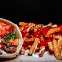 Lamb Gyro Wrap · Fresh pita bread filled with gyro, crisp lettuce and sauteed onions drizzled with white sauc...