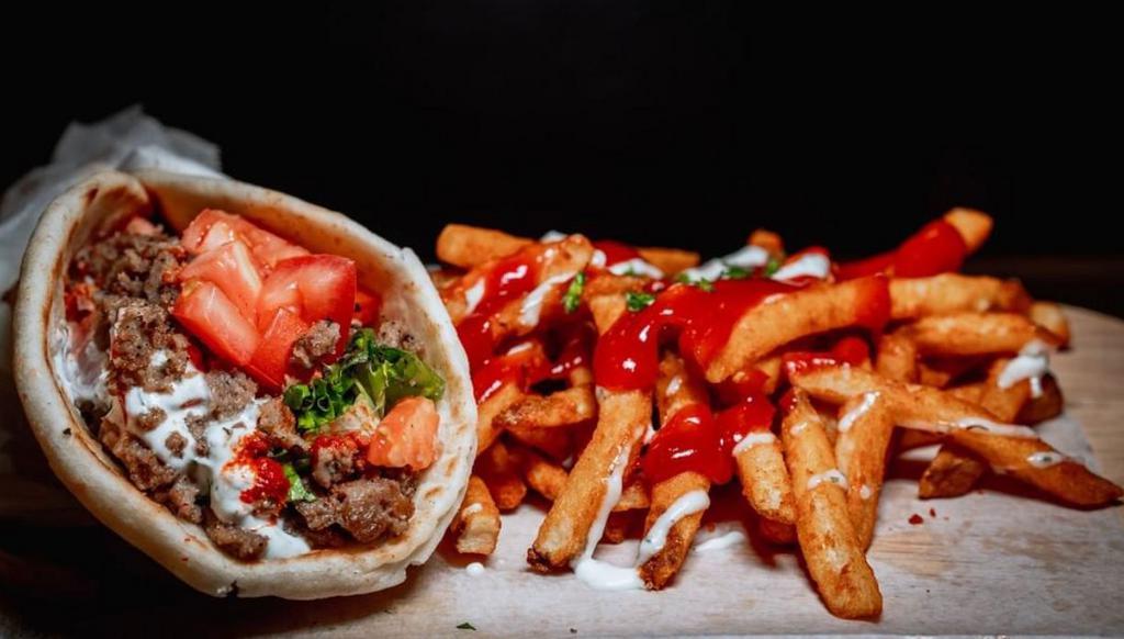 Lamb Gyro Wrap · Fresh pita bread filled with gyro, crisp lettuce and sauteed onions drizzled with white sauce. 
Ingredients: lamb, pita bread, fries, tomatoes, lettuce, onions, yogurt, hot sauce. 

All our products are halal. 