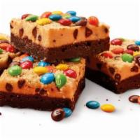 COOKIE DOUGH BROWNIE MADE WITH M&M’S® MINIS CHOCOLATE CANDIES · Brownie topped with Cookie Dough Frosting and M&M’S® Minis Chocolate Candies