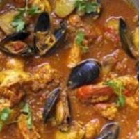 Sri Lankan Seafood Curry · Prawns, scallops salmon and mussels cooked in coconut, mustard seeds, curry leaves and dry r...