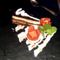 Fusion Temptation · A Divine Moist Chocolate cake topped with Hazelnut cream&Crunch,Layered with Choc-glaze&spri...