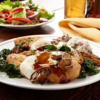 Chicken Madeira · Pan-seared chicken breasts topped with sautéed spinach, Madeira mushroom sauce and melted fr...
