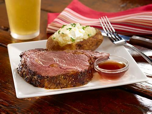 Queen Cut Prime Rib · 10 oz hand-carved to order, our prime rib is slow roasted daily with our special dry rub. Includes your choice of a house salad with balsamic vinaigrette or Caesar salad and one side.
