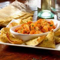 Garlic Buffalo Shrimp · Succulent shrimp sautéed in buffalo garlic sauce.  Served with garlic bread for dipping.  