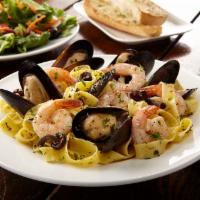 Seafood Tagliatelle · Tagliatelle pasta, mussels and shrimp tossed in  lemon garlic sauce.  Served with garlic bre...