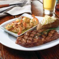Grilled Ribeye & Shrimp Scampi · A hand-cut, 10 oz. ribeye grilled to order and served with garlic shrimp scampi and choice o...
