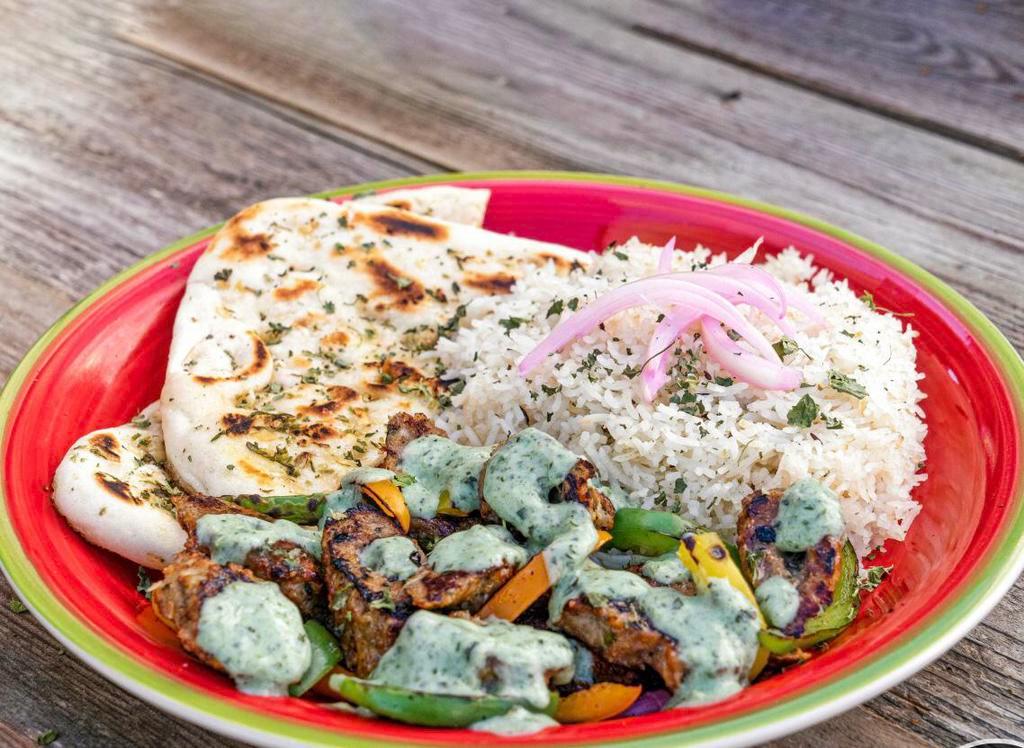 Chicken Kebab plate · Grilled skewered meat served with rice, naan, bell peppers, lettuce, pickled onions and mint chutney