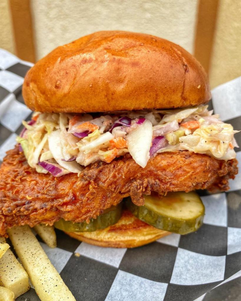 Vegas Hot Chicken Sandwich · Buttermilk fried chicken, dipped in hot pepper oil with pickles and slaw on a brioche bun. Served with fries.