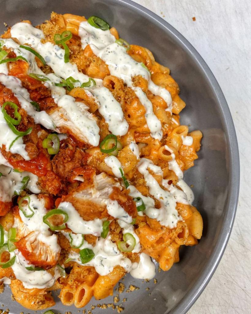 Loaded Mac n Cheese · Mac n cheese topped with garlic breadcrumbs, boneless wings with ranch and green onions!