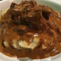 BRC Liver · Fried veal liver with roasted onions in a cream sauce served over mashed potatoes.