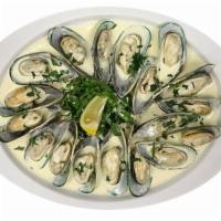 Mussels · Steamed fresh mussels drenched in a delicious white wine sauce. Served with cabbage salad an...