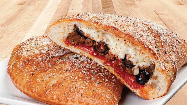 Classic Combo Calzone · A soft and chewy oven-baked pocket brushed with our signature sauce and stuffed with premium pepperoni, savory sausage, seasoned beef, diced onions, black olives, mushrooms and lots of mozzarella cheese. Served with our classic marinara.