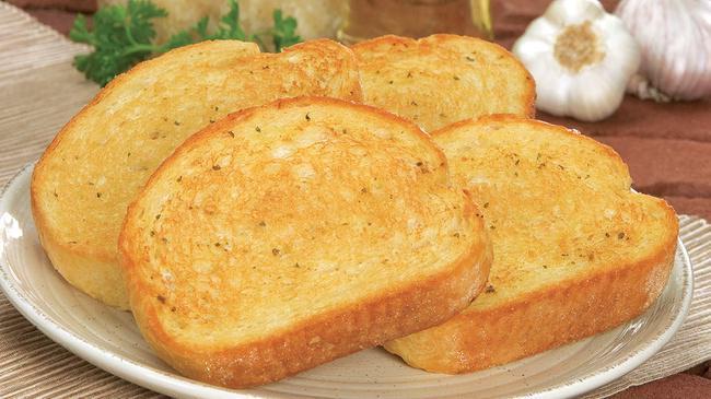 Garlic Bread · Oven-baked bread, brushed with a buttery Garlic Sauce and sprinkled with a blend of spices. 4 pieces.