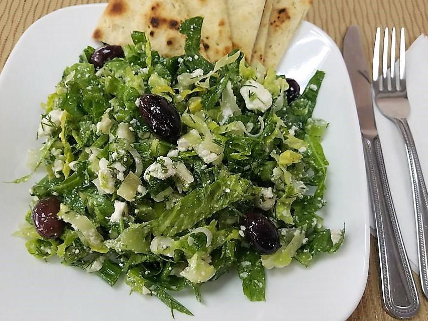 Prassini Salad · Green salad. Finely chopped ice berg lettuce tossed with dill, parsley, scallions, crumbled feta cheese and our Greek dressing. Served with pita bread.